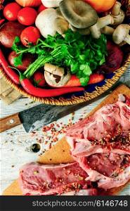 Steak of beef with vegetables preparation for cooking. Fresh cut meat