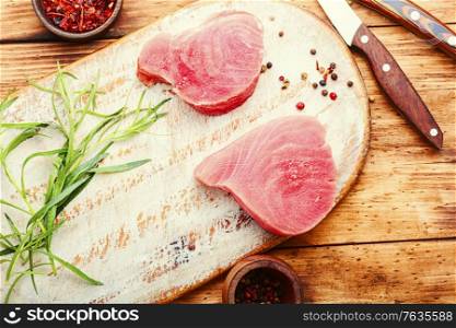 Steak of tuna fish on on cutting board.. Raw tuna fish