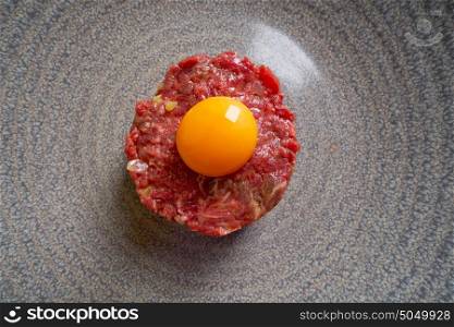 Steak Tartare raw meat recipe with egg yolk modern cuisine