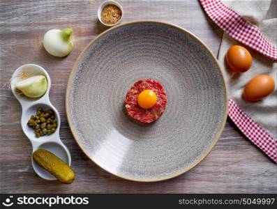 Steak Tartare raw meat recipe with egg yolk modern cuisine