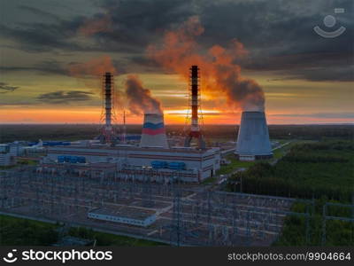 Steam from the power plant cooling towers. A view of the power plant pipes at sunset.. Steam from power plant cooling towers. A view of the power plant pipes at sunset.