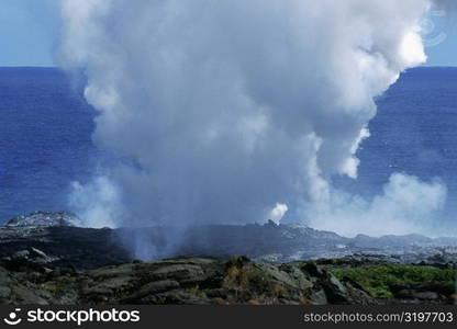 Steam rises from lava flowing into the sea, Hawaii