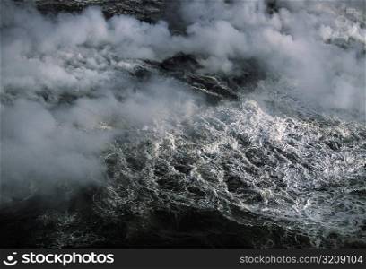 Steam rises from lava flowing into the sea, Hawaii