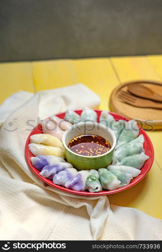 steamed chives dumplings served with spicy chili sauce , asian style cuisine. steamed chives dumplings