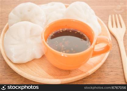 Steamed dumpling stuff on wooden plate, photo