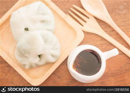 Steamed dumpling stuff serving on wooden plate, stock photo