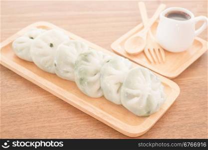 Steamed dumpling stuff serving on wooden plate, stock photo