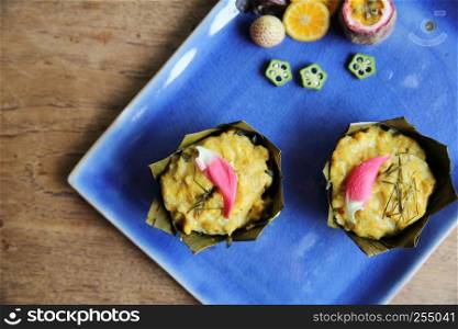 steamed fish with curry paste on wood background