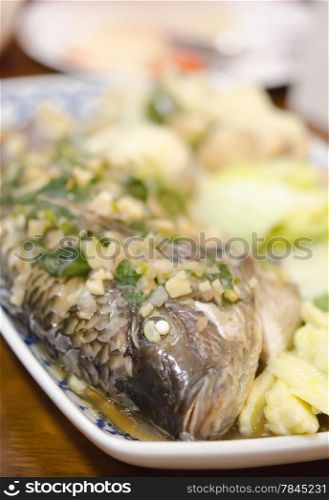 steamed fish with garlic , herbs and vegetable