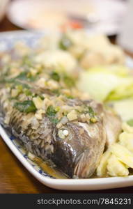 steamed fish with garlic , herbs and vegetable