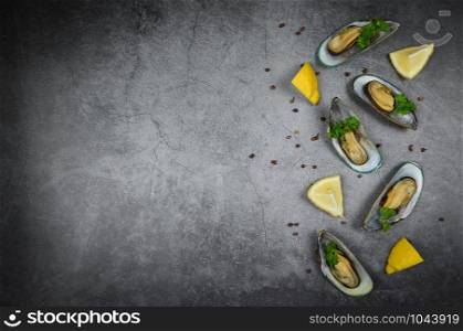 Steamed mussels served on plate seafood delicious on dining table restaurant / Mussels with herbs with lemon parsley stone table Top view with copy space