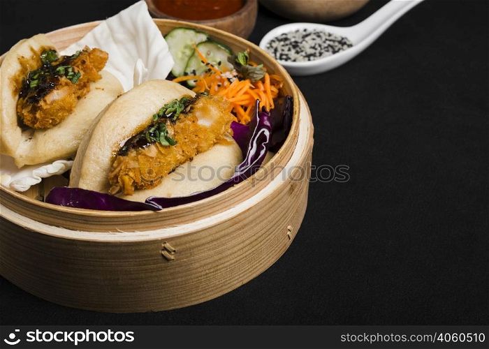steamed sandwich bamboo steamer with salad black background