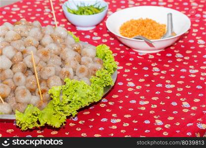 Steamed tapioca balls with peanut and pork filling.