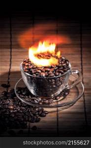 Steaming cup of coffee, cinnamon sticks and a coffee beans on fire. Steaming cup of coffee on fire
