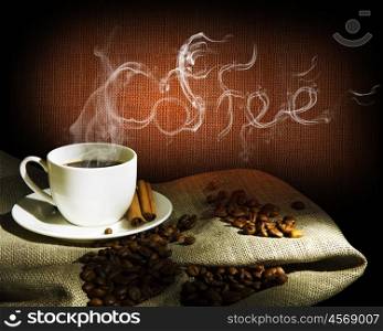 Steaming cup of coffee, cinnamon sticks and a few coffee beans. still life