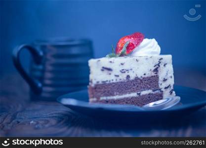 Steaming hot coffee and chocolate and cheese cake on wood background