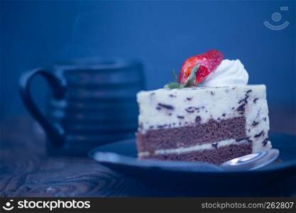 Steaming hot coffee and chocolate and cheese cake on wood background
