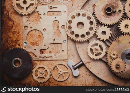 Steampunk background from mechanical clocks details over old metal background. Inside the clock, gears