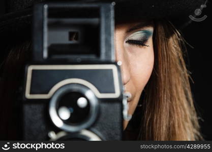 Steampunk. Closeup retro woman with old vintage camera studio shot grunge dark background