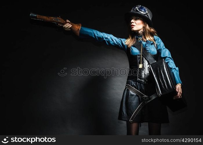 steampunk retro woman with bag suitcase and gun studio shot grunge dark background