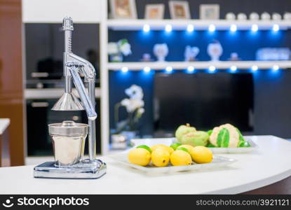 steel citrus juicer on the kitchen table