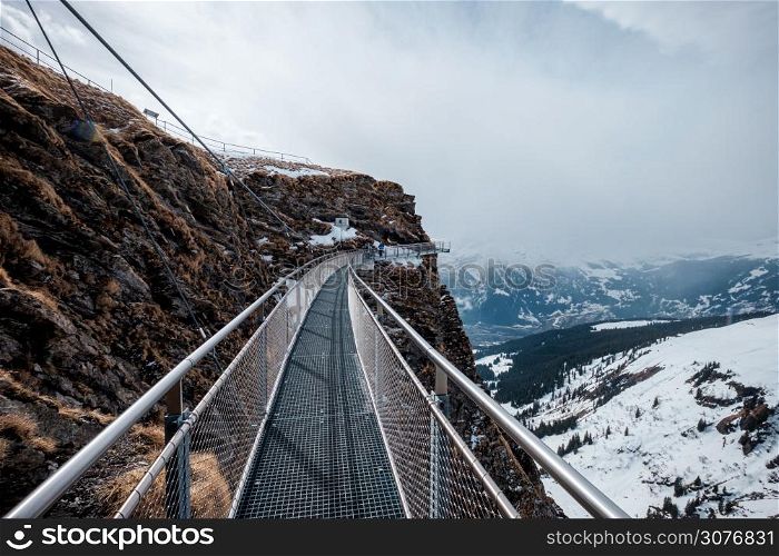 Steel cliff walk over snowy alps at the First station in Grindelwald, Switzerland