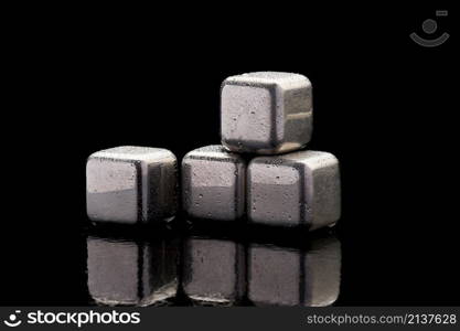 Steel cooling cubes for cocktail drink on glass background.. Steel cooling cubes for cocktail drink on glass background