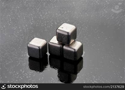 Steel cooling cubes for cocktail drink on glass background.. Steel cooling cubes for cocktail drink on glass background