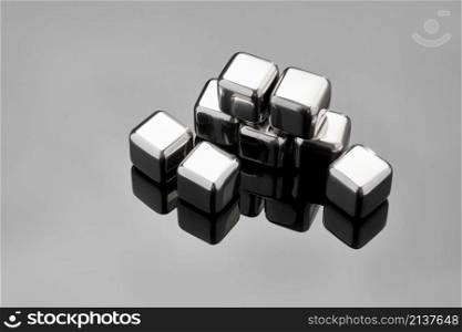 Steel cooling cubes for cocktail drink on glass background.. Steel cooling cubes for cocktail drink on glass background
