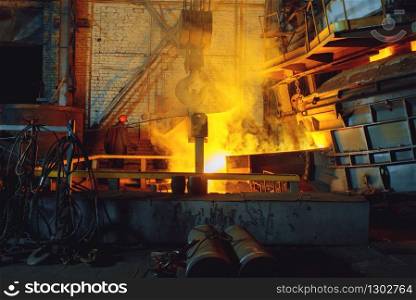 Steel factory, metallurgical or metalworking industry, industrial manufacturing of production on mill, crane over furnace with liquid metal. Steel factory, metallurgical or metalworking mill