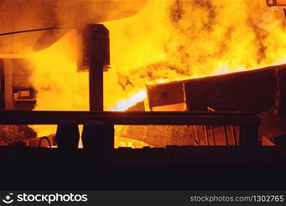 Steel factory, metallurgical or metalworking industry, industrial manufacturing of production on mill, crane over furnace with liquid metal, closeup. Steel factory, metallurgical or metalworking mill