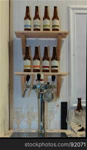 Steel Plank for Beer Tapping: Glasses and Bottles on Shelves in background