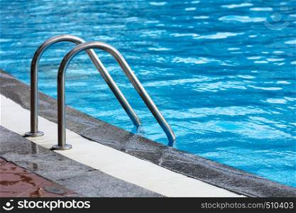 steel railings stairs pool with reflection