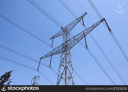 Steel support of overhead power transmission line on sky background