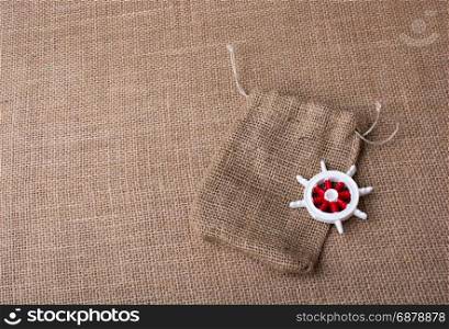 Steering wheel of a boat on a sack on canvas
