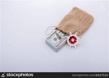 steering wheel on Banknote bundle of US dollarin a sack