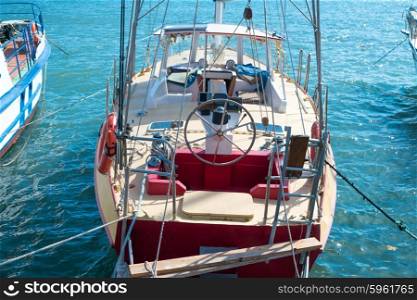 Steering wheel on the yacht with blue sea water background