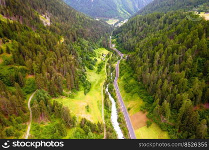 Stelvio pass road and river canyon in Dolomites Alps aerial view, province of South Tyrol in northern Italy.