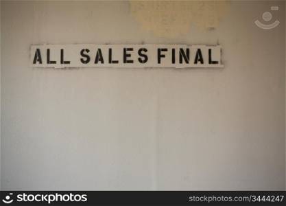 ""Stencil of ""All Sales Final"" on Blank Wall""
