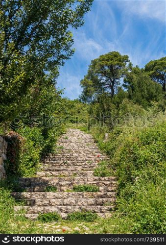 Steps leading to ruins of old Venetian fort above the coastal town of Novigrad in Croatia. Steps to fortress above the Croatian town of Novigrad in Istria County
