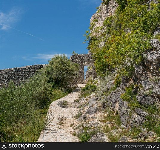 Steps leading to ruins of old Venetian fort above the coastal town of Novigrad in Croatia. Steps to fortress above the Croatian town of Novigrad in Istria County