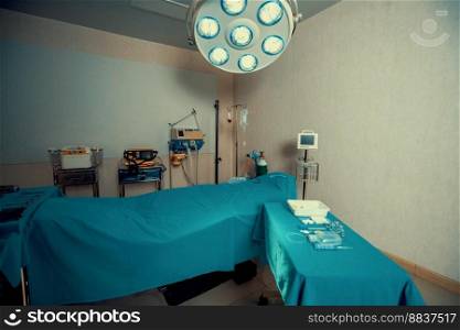 Sterile operation room in the hospital display sets of medical surgical equipments arranged on the table. Surgery room with surgical tools background for medical purpose.. Sterile operation room in hospital display sets of medical surgical equipments.