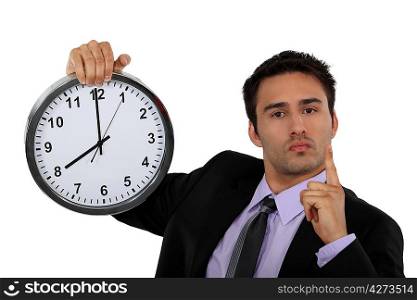Stern businessman with a clock