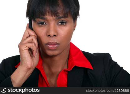 Stern businesswoman making call