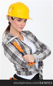 Stern looking female builder with hammer