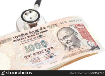 Stethoscope and indian 1000 rupee notes isolated