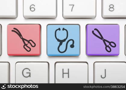 Stethoscope and medical scissors key on keyboard