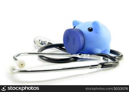 Stethoscope and piggy bank showing medical or financial concept. Stethoscope and piggy bank