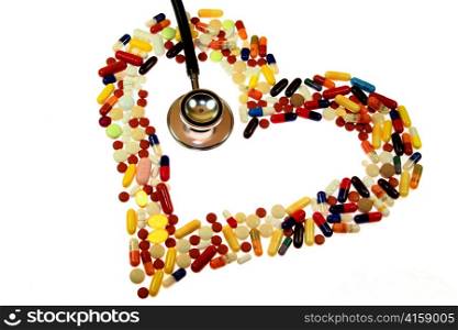 stethoscope and pills on a white background. symbolic photo for heart disease
