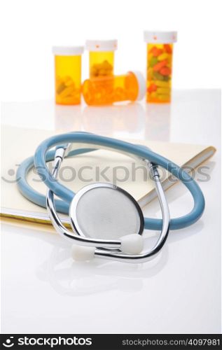 Stethoscope file folder and pill bottles with reflections